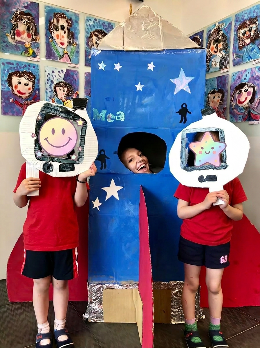 Children playing with a cardboard rocket